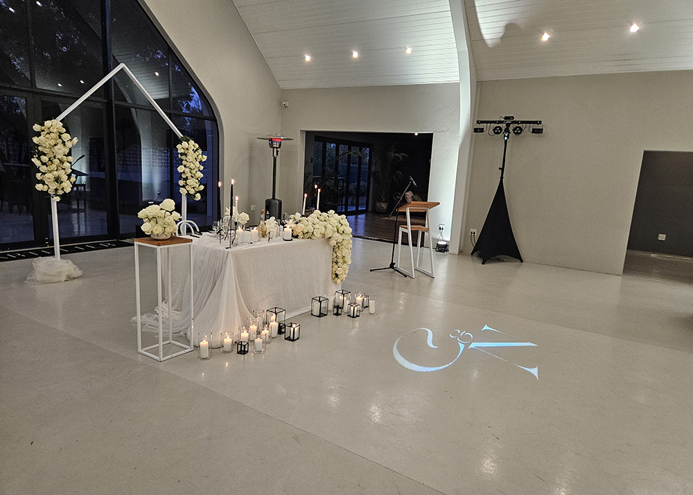 Wedding reception venue featuring a personalised gobo projection and elegant ambient lighting