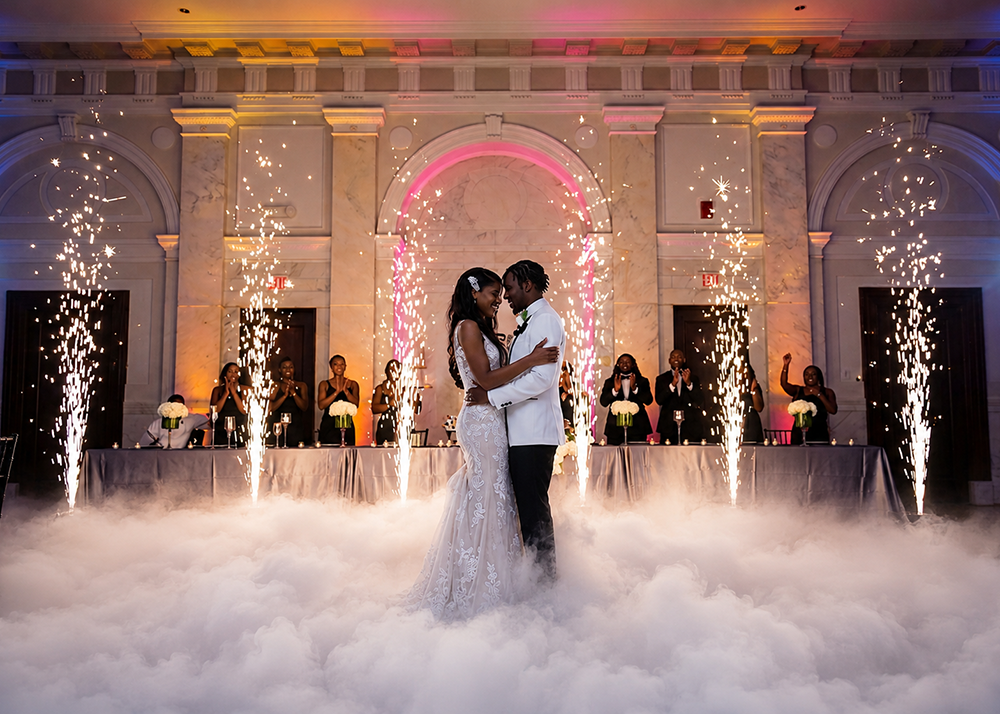 Bride and groom celebrating with indoor cold sparkler effects and dry ice at a luxury wedding