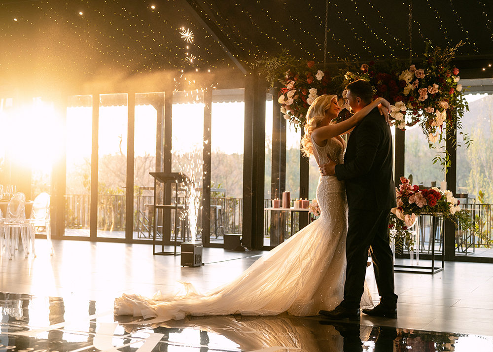 Bride and groom captured during their wedding reception by professional photography and videography services